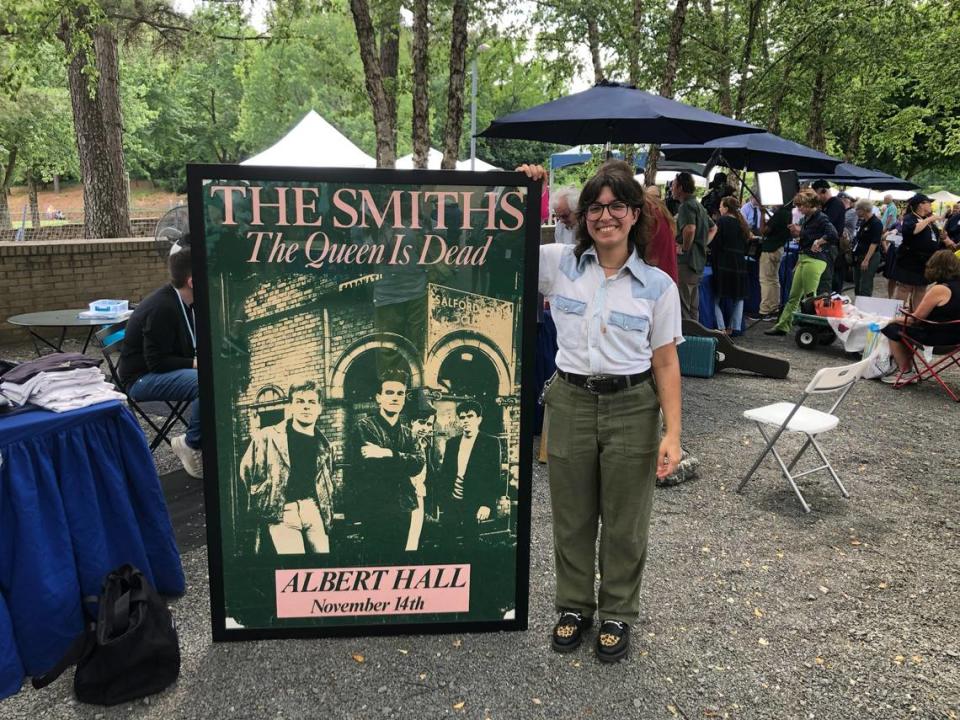 A visitor to the Raleigh, NC taping of “Antiques Roadshow” with a concert poster from The Smiths show in London.