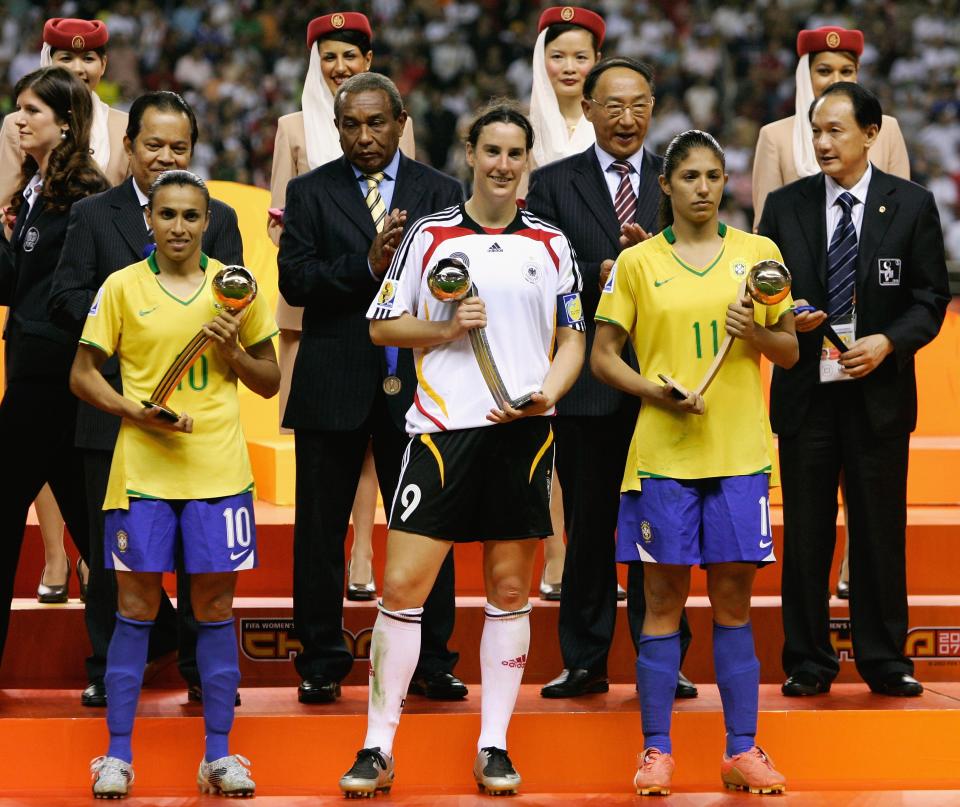 SHANGHAI, CHINA - SEPTEMBER 30: (L-R) Marta of Brazil is honored with the adidas golden ball, Birgit Prinz of Germany is honored with the adidas silver ball and Christiane of Brazil is honored with the adidas bronze ball after the Women's World Cup 2007 Final match between Brazil and Germany at the Shanghai Hongkou Football Stadium September 30, 2007 in Shanghai, China. (Photo by Christof Koepsel/Bongarts/Getty Images)