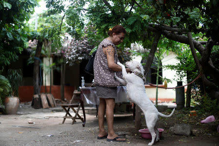 Felina, 50, an indigenous Zapotec transgender woman also know as Muxe, says goodbye to her dog inside her house destroyed after an earthquake that struck on the southern coast of Mexico late on Thursday, in Juchitan, Mexico, September 10, 2017. Picture taken, September 10, 2017. REUTERS/Edgard Garrido