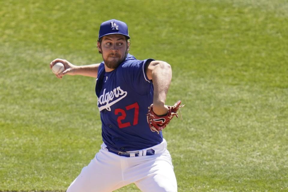 A man in a blue Dodgers uniform with the number 27 pitches a baseball