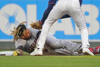 Cleveland Indians' Jose Ramirez lies on the base path after being tagged out, trying to stretch a single into a double, by Minnesota Twins shortstop Nick Gordon during first inning of a baseball game Wednesday, Sept. 15, 2021, in Minneapolis. (AP Photo/Jim Mone)