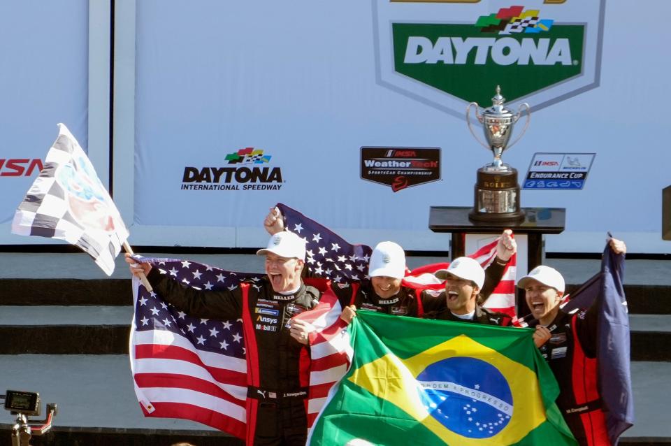Josef Newgarden (left) celebrates with his teammates following their win in the Rolex 24.