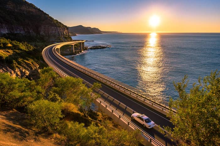 A car driving next to the ocean