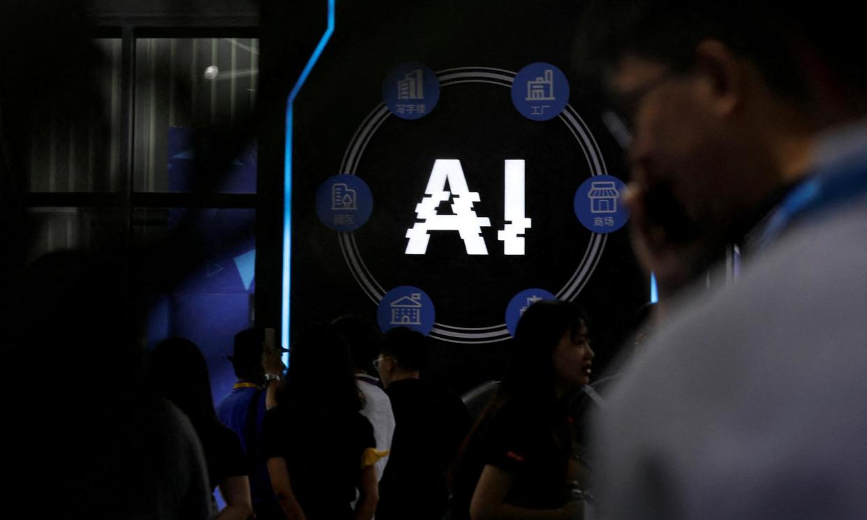 <span>Visitors stand near a sign at an artificial intelligence robot booth at an exhibition in China.</span><span>Photograph: Florence Lo/Reuters</span>