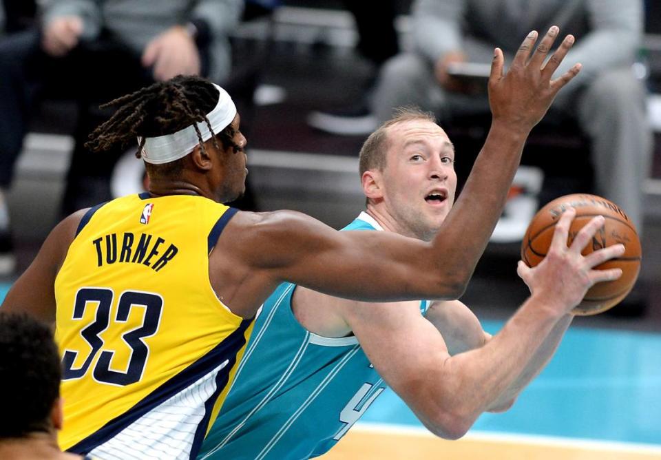 Charlotte Hornets center Cody Zeller, right, looks to fake Indiana Pacers forward/center Myles Turner on a shot attempt during second half action Friday.