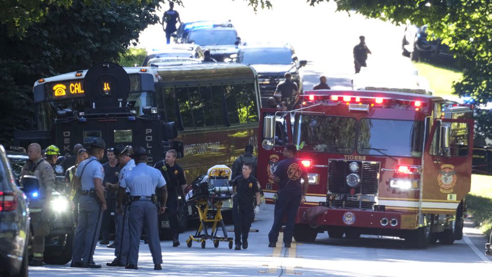 Emergency vehicles surround the hijacked bus after a harrowing chase through two Atlanta-area counties. - Ben Gray/AP