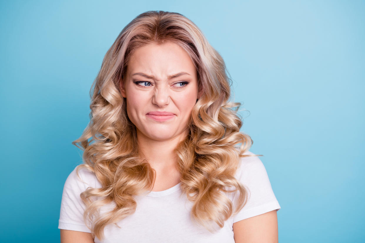 Close up photo beautiful her she lady awful awkward situation look hate mad rage outraged ugh facial expression wear casual white t-shirt jeans denim clothes outfit isolated bright blue background.