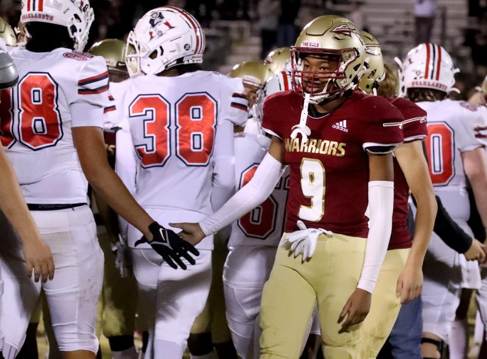 Riverdale's Zyntreacs Otey (9) shakes hands with the Oakland team after Riverdale lost 56-0 in the football playoff game at Riverdale High School on Friday, November 17, 2023.