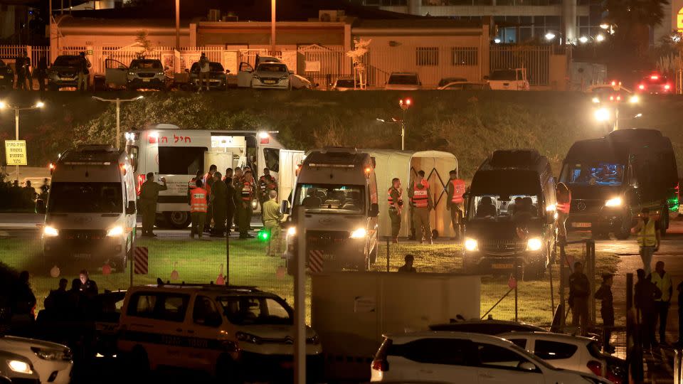 Israeli security forces and ambulances wait outside the helipad of Tel Aviv's Schneider Medical Centre on Friday. - Fadel Senna/AFP/Getty Images