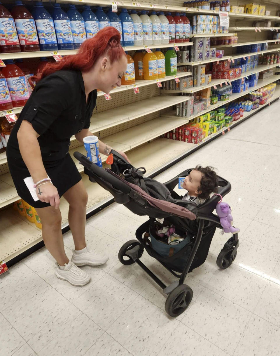 This undated photo provided by Deatrie Young shows Jazmin Valentine and her baby at a supermarket. Valentine filed a federal lawsuit Tuesday, Sept. 27, 2022, alleging that nurses and staff at the Washington County jail in Maryland ignored her screams and plea for help as she gave birth to her daughter there in July 2021. (Deatrie Young via AP)