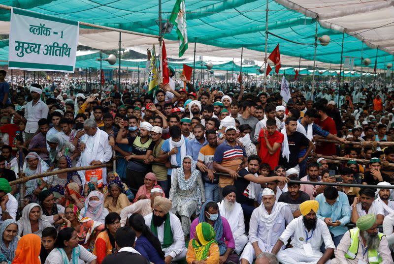 People attend a Maha Panchayat or grand village council meeting as part of a farmers' protest against farm laws in Muzaffarnagar