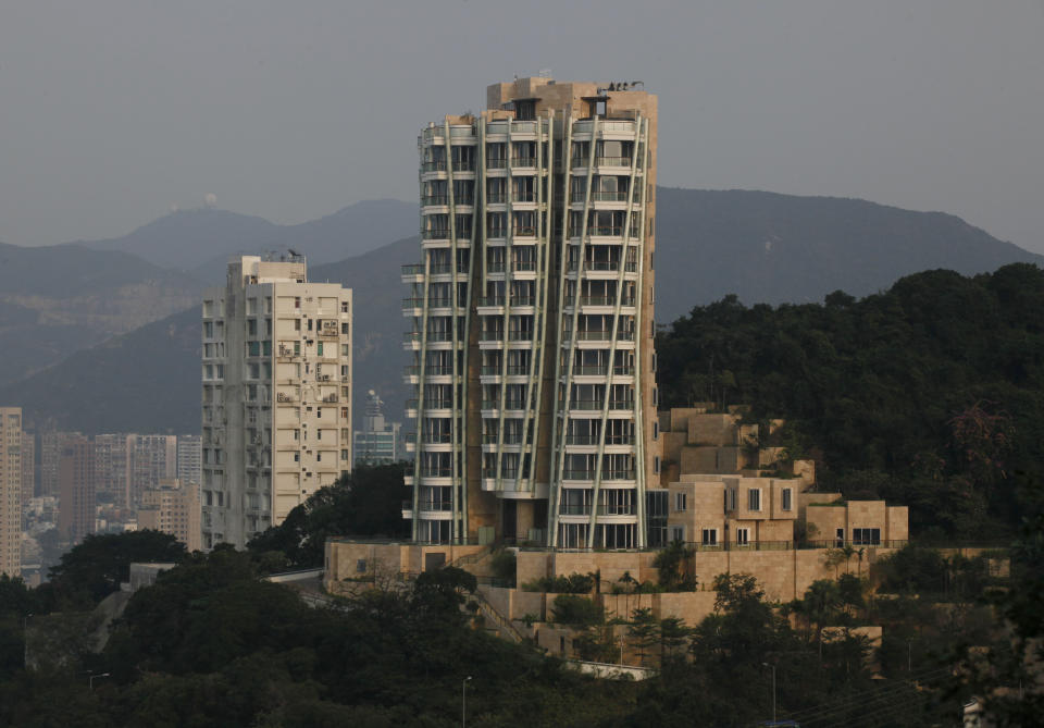 The luxury residential building "Opus Hong Kong," right, designed by Frank Gehry soars in Mid-Levels East of Hong Kong Tuesday, Nov. 13, 2012. A Hong Kong property company has sold a luxury apartment in the Frank Gehry-designed building for an eye-popping price of nearly $60 million dollars. Swire Properties said Tuesday it sold the 620 square meter (6,683 square foot) apartment on the ninth floor of its Opus development for 455 million Hong Kong dollars ($58.7 million). It did not say who the buyer was. (AP Photo/Kin Cheung)