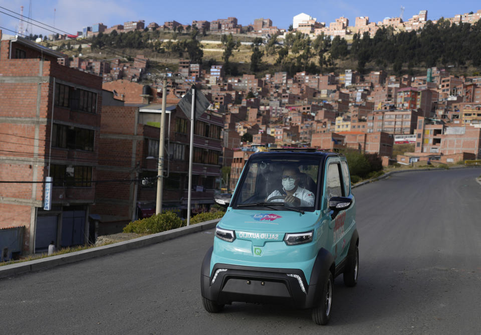 Dr. Carlos Ortuno drives a Bolivian-made, Quantum electric car to a house call, in La Paz, Bolivia, Wednesday, May 3, 2023. Launched in 2019, Quantum Motors has only sold 350 electric cars in Bolivia. But their founders recently received a boost from the German city of Bonn, which invested 50,000 euros to acquire six units in support of a local program that sends doctors to people's homes. (AP Photo/Juan Karita)