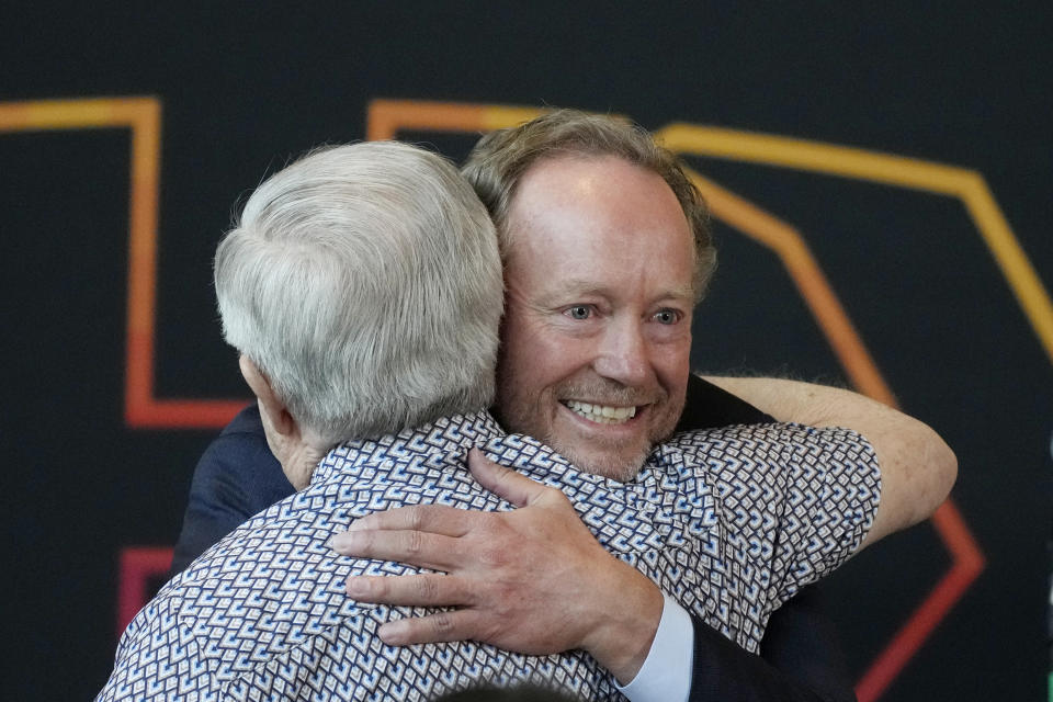 New Phoenix Suns head coach Mike Budenholzer, right, gets a hug from retired longtime Suns broadcaster Al McCoy during an NBA basketball news conference introducing Budenholzer, Friday, May 17, 2024, in Phoenix. (AP Photo/Ross D. Franklin)