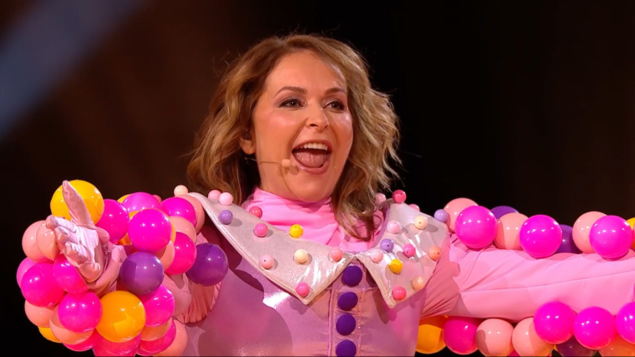 the masked singer uk unmasks bubble tea as julia sawalha, who is wearing a pink costume covered in plastic balls