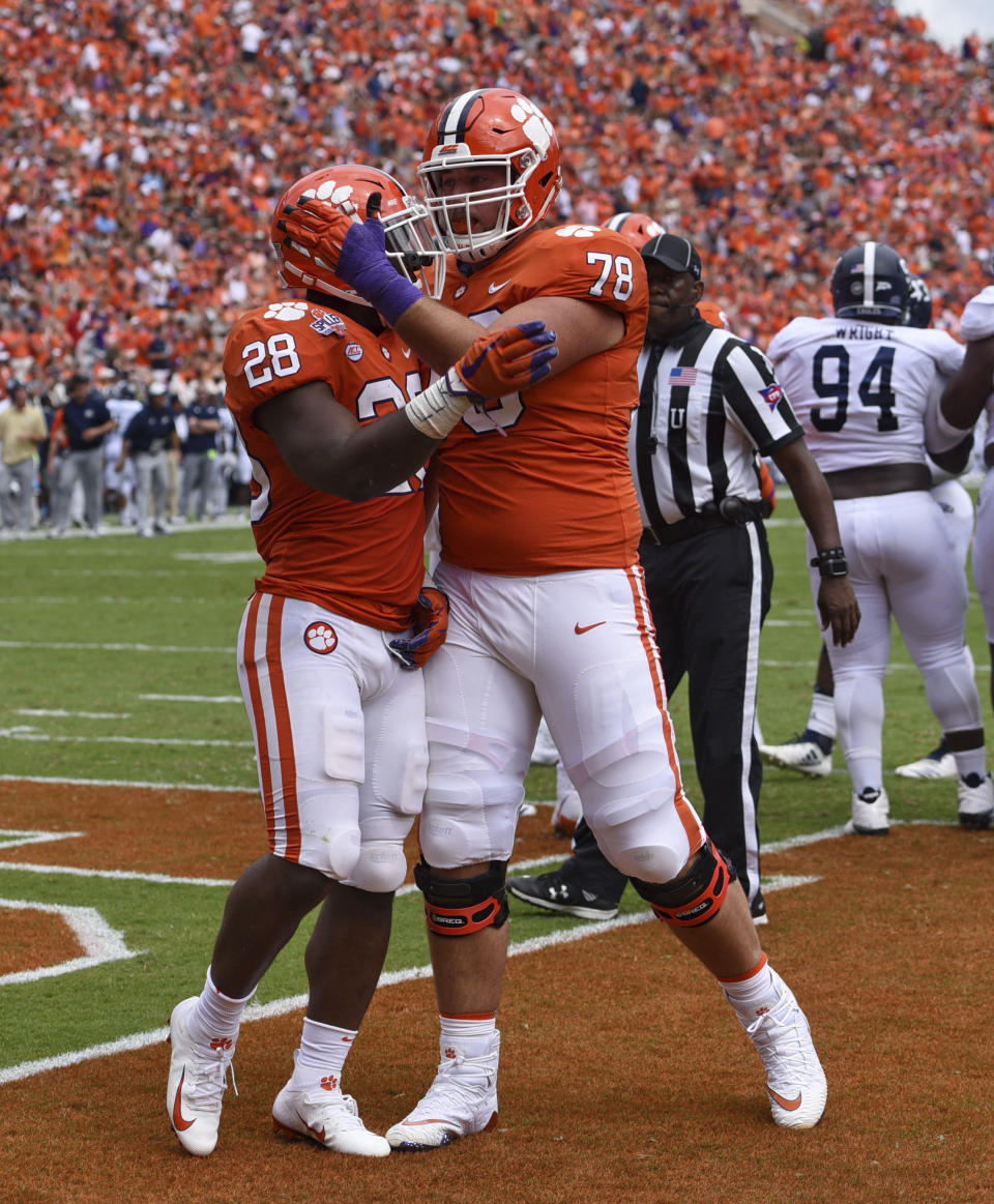 Clemson's Tavien Feaster (28) celebrates his touchdown with Chandler Reeves during the first half of an NCAA college football game against Georgia Southern, Saturday, Sept. 15, 2018, in Clemson, S.C. (AP Photo/Richard Shiro)