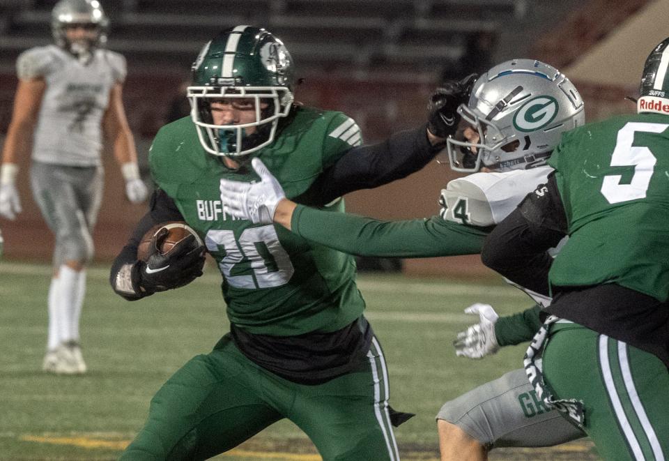 Manteca's Blake Nichelson, left, fends off Granite Bay's Joseph Cattolico during the CIF Sac-Joaquin Section Division II football championship game at Hughes Stadium in Sacramento on Saturday, Nov. 26, 2022. 