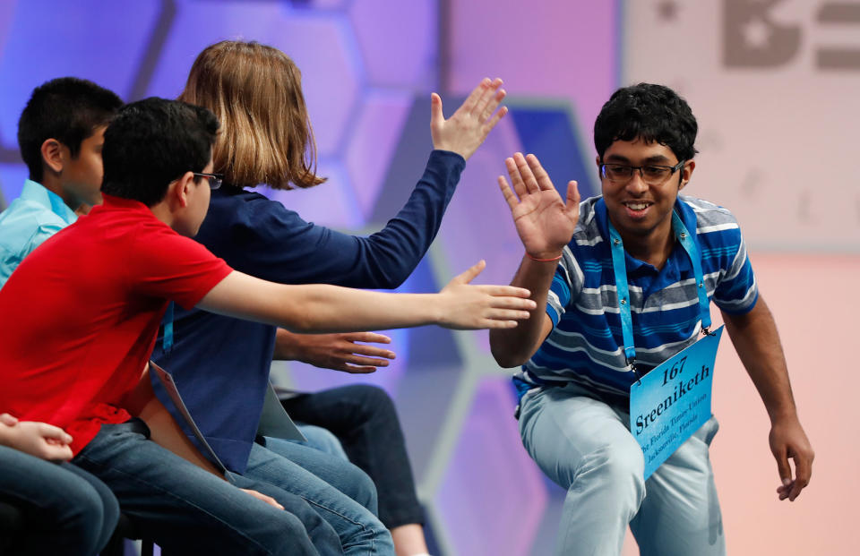 <p>Sreeniketh Vogoti, 14, from Saint Johns, Fla., right, celebrates with his fellow spellers after spelling his word correctly during the 90th Scripps National Spelling Bee, Thursday, June 1, 2017, in Oxon Hill, Md. (AP Photo/Alex Brandon) </p>