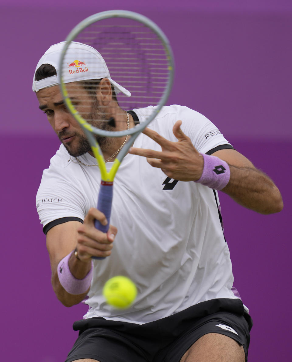 Matteo Berrettini of Italy plays a return to Andy Murray of Britain during their singles tennis match at the Queen's Club tournament in London, Thursday, June 17, 2021. (AP Photo/Kirsty Wigglesworth)