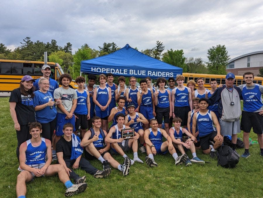 The Hopedale boys' track team celebrates winning the Dual Valley Conference title on Monday at Douglas High. It was the first outdoor title in school history.