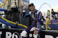 Romain Grosjean (51) sits on the pit wall before the start an IndyCar auto race at World Wide Technology Raceway on Saturday, Aug. 21, 2021, in Madison, Ill. (AP Photo/Jeff Roberson)