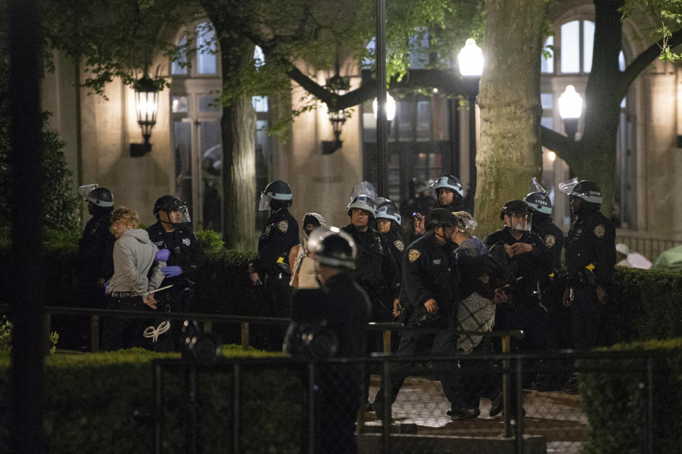 Officers with the New York Police Department arrest Pro-Palestinian protesters at Columbia University, Tuesday, April 30, 2024, in New York. The protesters had seized the administration building, known as Hamilton Hall, more than 20 hours earlier in a major escalation as demonstrations against the Israel-Hamas war spread on college campuses nationwide. (Marco Postigo Storel via AP)