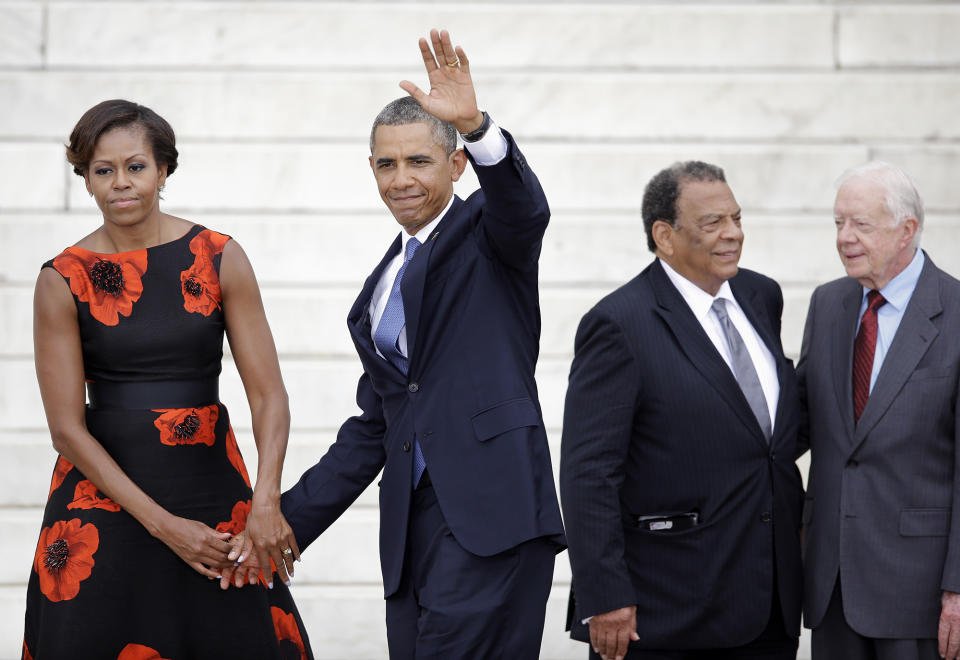 President Barack Obama and First Lady Michelle Obama as well as former United Nations Ambassador Andrew Young and former President Jimmy Carter at the Lincoln Memorial in 2013 for a ceremony commemorating the 50th anniversary of the March on Washington.