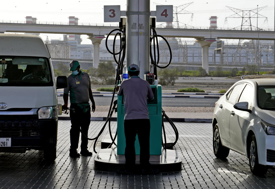 A gas station attendant fills a gas tank in Dubai, United Arab Emirates, Sunday, July 10, 2022. Mere years ago, fuel was cheaper than bottled water in the oil-rich United Arab Emirates. Now, long lines snake outside gas stations on the eve of monthly price hikes. (AP Photo/Kamran Jebreili)