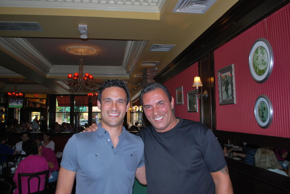 In this July 18, 2015, photo provided by Brad Balukjian, Brad Balukjian, left, stands with former major league outfielder Lee Mazzilli in Rye, N.Y. Balukjian tore open a pack of 1986 Topps baseball cards, chewed the stale, brittle bubblegum and then planned a journey most sports fans could only dream about. The self-funded trip in 2015, to meet every player whose image appeared on those old pieces of cardboard, cost about $8,000 and took him across 30 states over 11,341 miles in 48 days — fueled by 123 cups of coffee. (Brad Balukjian via AP)