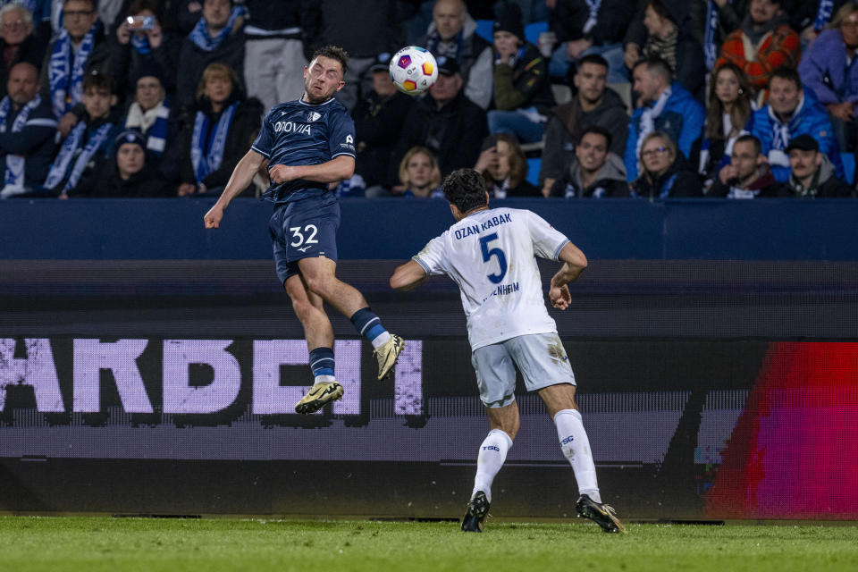 Bochum's Maximilian Wittek, left, and Hoffenheim's Ozan Kabak battle for the ball during the Bundesliga soccer match between VfL Bochum and TSG 1899 Hoffenheim at Vonovia Ruhrstadion, Bochum, Germany, Friday April 26, 2024. (David Inderlied/dpa via AP)