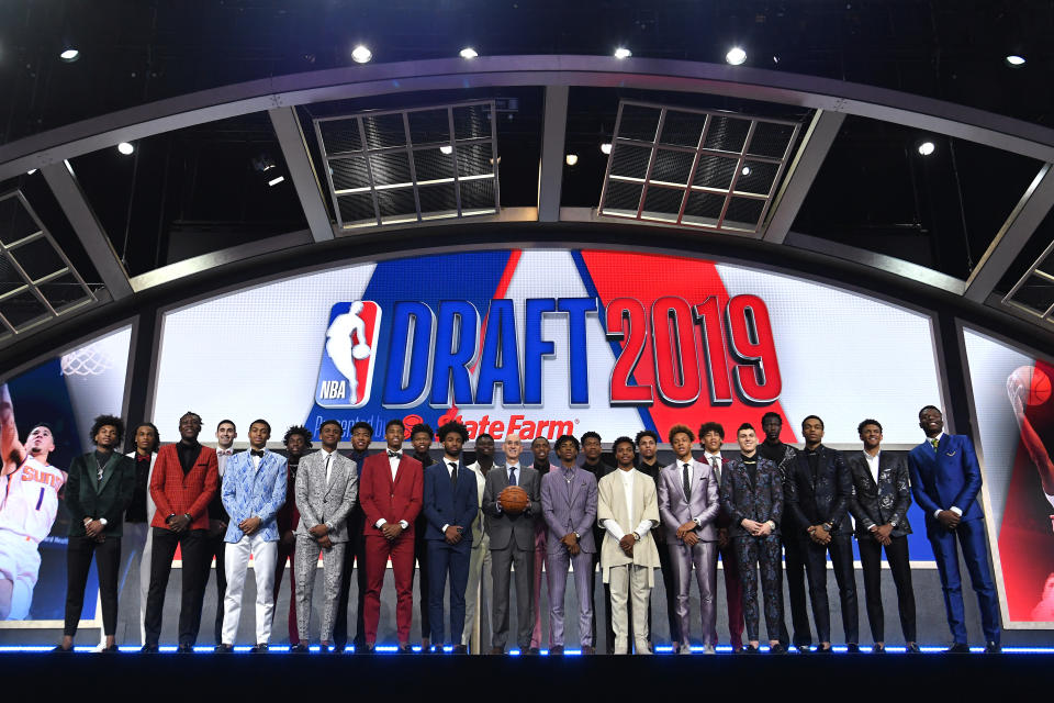 NEW YORK, NEW YORK - JUNE 20: (L-R) NBA Draft prospects Kevin Porter Jr., Nicolas Claxton, Sekou Doumbouya, Goga Bitazde, Keldon Johnson, Nassir Little, Nickeil Alexander-Walker, Rui Hachimuri, Jarrett Culver, Cam Reddish, Coby White, Zion Williamson, NBA Commissioner Adam Silver, Ja Morant, De'Andre Hunter, Darius Garland, Brandon Clarke, Romeo Langford, Jaxson Hayes, Tyler Herro, Bol Bol, PJ Washington, Matisse Thybulle and Mfiondu Kabengele stand on stage with NBA Commissioner Adam Silver before the start of the 2019 NBA Draft at the Barclays Center on June 20, 2019 in the Brooklyn borough of New York City. NOTE TO USER: User expressly acknowledges and agrees that, by downloading and or using this photograph, User is consenting to the terms and conditions of the Getty Images License Agreement. (Photo by Sarah Stier/Getty Images)