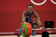 Zacarias Bonnat Michel of Dominican Republic reacts to an unsuccessful attempt as he competes in the men's 81kg weightlifting event, at the 2020 Summer Olympics, Saturday, July 31, 2021, in Tokyo, Japan. (AP Photo/Luca Bruno)