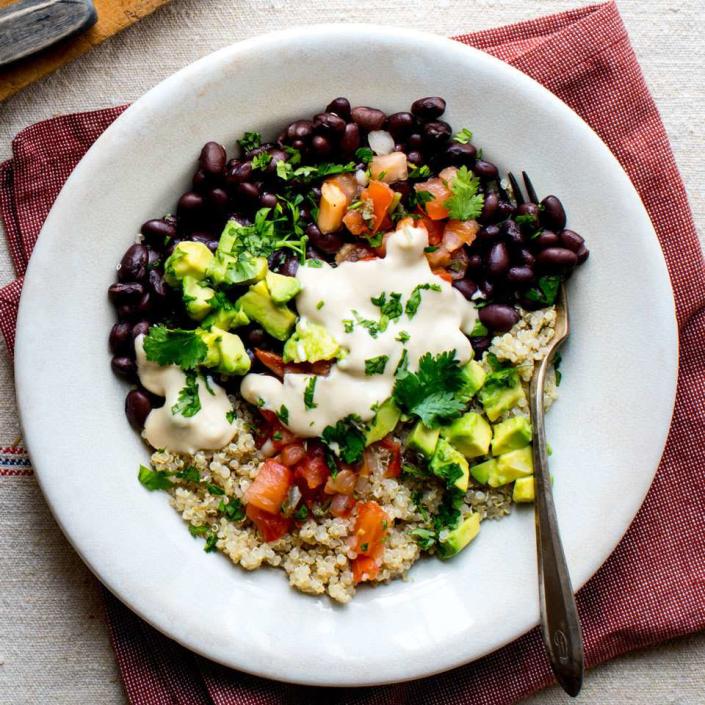 <p>This black bean and quinoa bowl has many of the usual hallmarks of a taco salad, minus the fried bowl. We've loaded it up with pico de gallo, fresh cilantro and avocado plus an easy hummus dressing to drizzle on top. <a href="https://www.eatingwell.com/recipe/260726/black-bean-quinoa-buddha-bowl/" rel="nofollow noopener" target="_blank" data-ylk="slk:View Recipe" class="link ">View Recipe</a></p>
