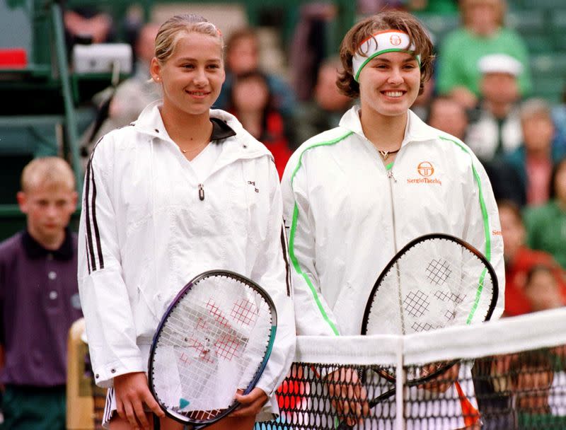 FILE PHOTO: Kournikova and Hingis pose for cameras at Wimbledon