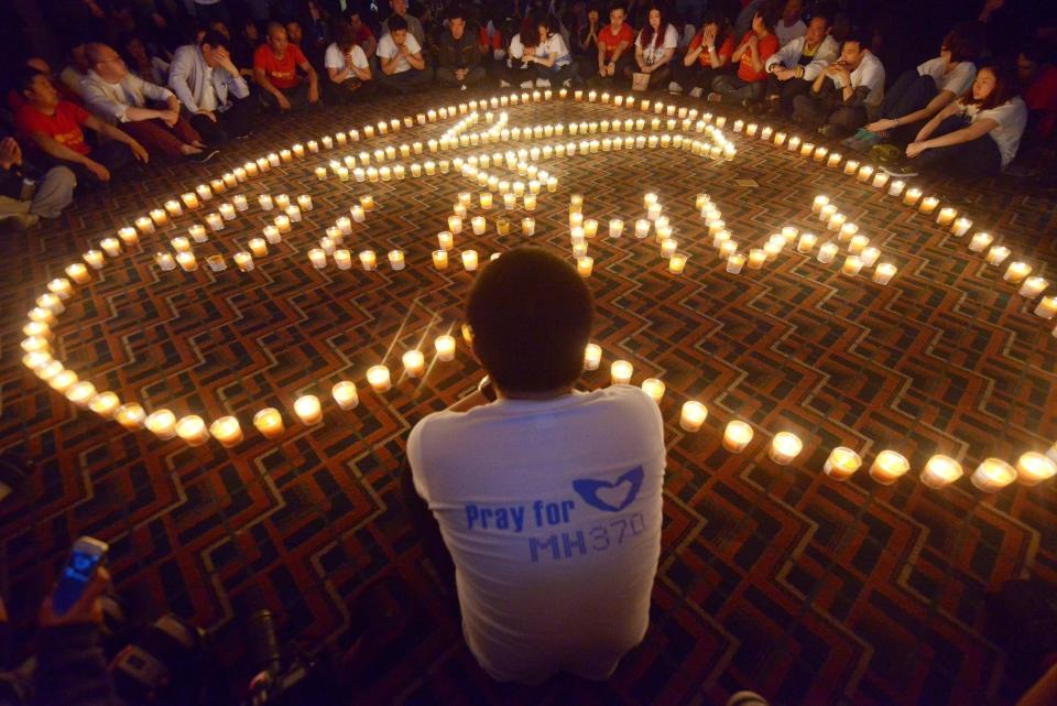 Chinese relatives of passengers on the missing Malaysia Airlines flight MH370 take part in a prayer service at the Metro Park Hotel in Beijing on April 8, 2014. / Credit: WANG ZHAO/AFP via Getty Images