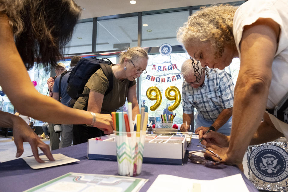 People write birthday cards for President Jimmy Carter during a celebration for his 99th birthday held at The Carter Center in Atlanta on Saturday, Sept. 30, 2023. (AP Photo/Ben Gray)