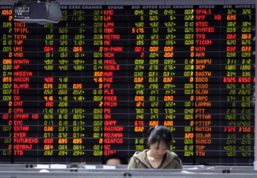 A Thai investor stands infront of an electronic shares price display at the stock exchange in Bangkok, 2009. Asian markets were generally higher, their third consecutive positive session, as traders looked for new stimulus measures from European and US central banks