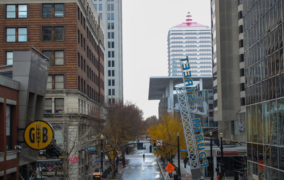 A few pedestrians along Fourth Street on a December afternoon recently. Downtown Louisville has experienced fewer people since 2020, according to a study of cell phone traffic. Dec. 5, 2023