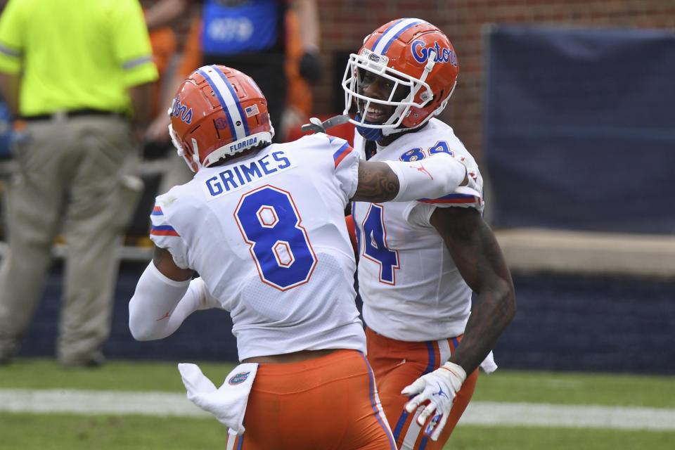 Florida tight end Kyle Pitts (84) and wide receiver Trevon Grimes (8) celebrate after a touchdown by Pitts during the second half of an NCAA college football game against Mississippi in Oxford, Miss., Saturday, Sept. 26, 2020. No. 5 Florida won 51-35. (AP Photo/Thomas Graning)