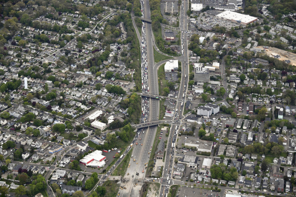 This aerial view looking south shows northbound traffic on Interstate 95 backed up as demolition crews work to finish removing the Fairfield Avenue bridge over Interstate 95, Saturday, May 4, 2024 in Norwalk, Conn. Crews are expected to finish removing the bridge by Sunday morning, and road repairs will be made. The tanker truck burst into flames under the overpass after colliding with two other vehicles Thursday. The cause remains under investigation. (Kevin Coughlin / All Island Aerial via AP)