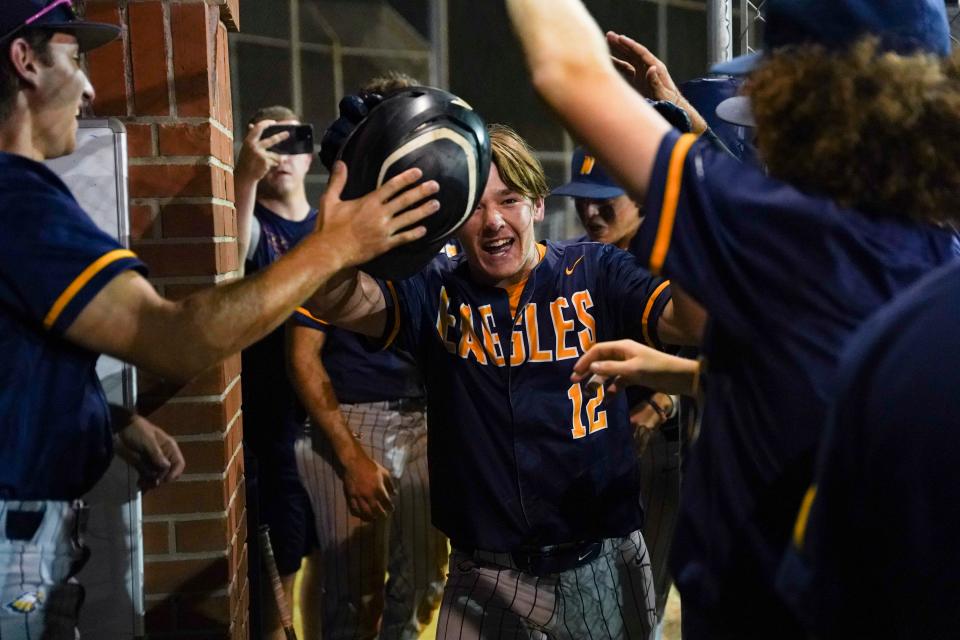 Naples Golden Eagles Vance Landry (12) celebrates with his teammates after hitting a solo home run during the sixth inning of the Class 5A Region 3 quarterfinal against the Seminole Warhawks at Naples High School on Tuesday, May 9, 2023.
