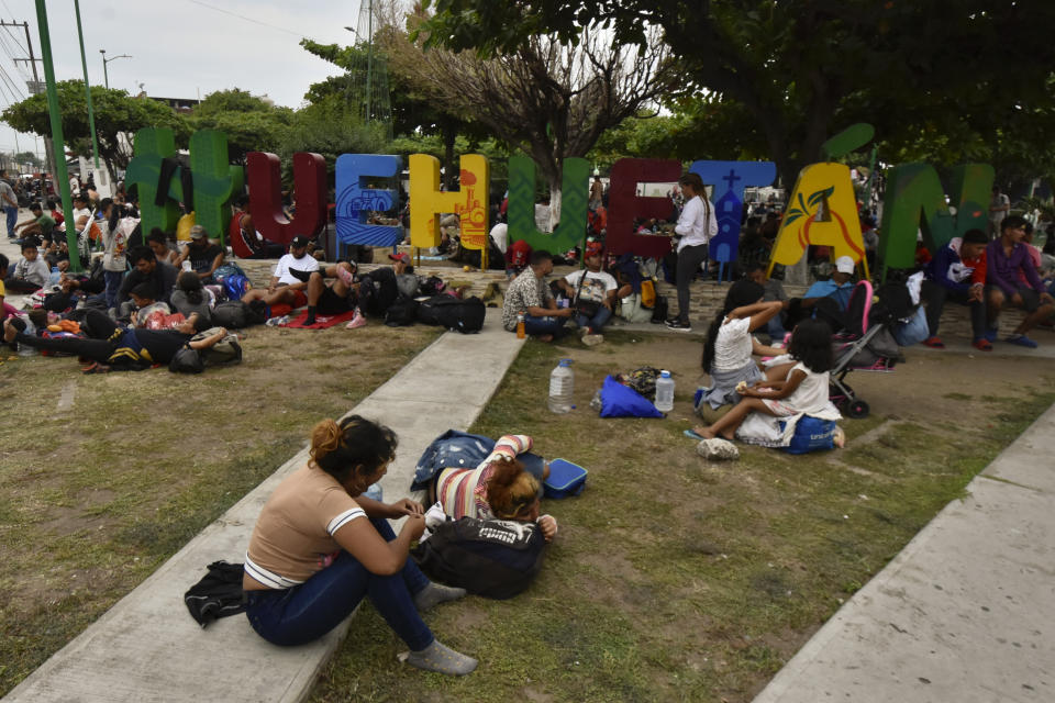 Migrants rest after arriving at Huehuetan, Chiapas state, Mexico, Monday, April 24, 2023. About 3,000 migrants began walking before dawn for a second day of protest march demanding the end of detention centers like the one that caught fire last month, killing 40 migrants. (AP Photo/Edgar H. Clemente)