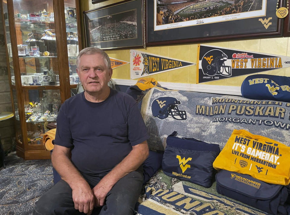 Terry Keenan is shown at his home Friday, Aug. 11, 2023, in Pond Gap, West Virginia. Keenan, a devout fan of West Virginia University football, says he doesn’t believe most college football fans will choose to make the longer trips to see their teams play on the road after conference realignment takes shape in 2024. (AP Photo/John Raby)