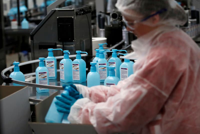 FILE PHOTO: An employee works on the production of hydroalcoholic gel at the Christeyns company's factory in Vertou