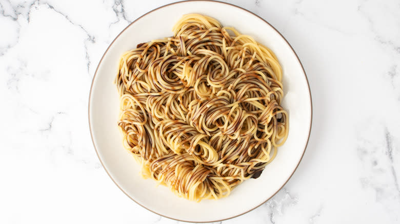 spaghetti with chocolate syrup on plate