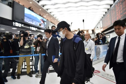 Badminton world number one Kento Momota arrived in Japan wearing a face mask after sustaining injuries in a road accident