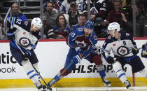 Winnipeg Jets right wing Nino Niederreiter, left, collects the puck as Colorado Avalanche right wing Valeri Nichushkin, center, and Winnipeg defenseman Josh Morrissey watch during the second period of Game 3 in an NHL hockey Stanley Cup first-round playoff series Friday, April 26, 2024, in Denver. (AP Photo/David Zalubowski)