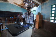 A man casts his vote at a polling station during a presidential run-off in Freetown, Sierra Leone March 31, 2018. REUTERS/Olivia Acland