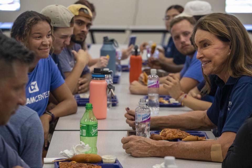 Caitlyn Jenner has lunch at a cafeteria table with several people