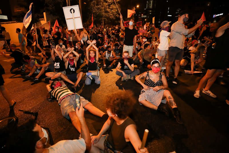 FILE PHOTO: Israelis protest against law that limits protests during coronavirus lockdown in Tel Aviv